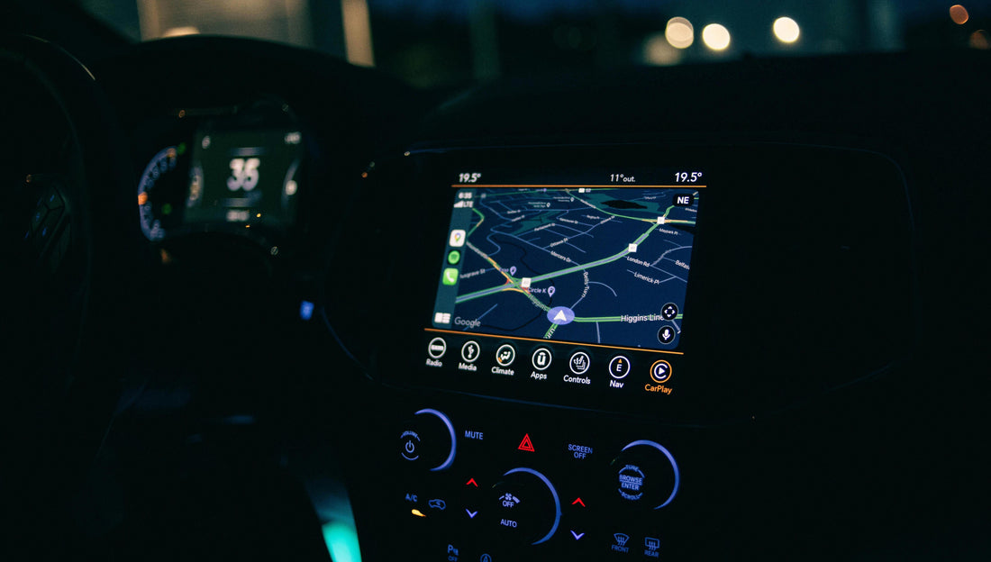 Wireless Apple CarPlay navigation displayed on a modern vehicle dashboard during nighttime driving with Apple Maps active on screen.