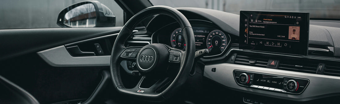 Audi car interior with steering wheel and dashboard showing Apple Carplay Interface