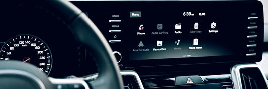 Car dashboard with infotainment system display showing apple carplay and android auto settings