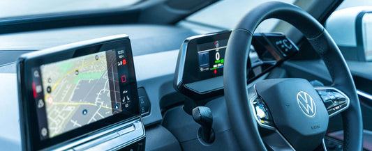 Volkswagen Passat interior with steering wheel and dashboard displaying a navigation system with Apple Carplay Interface through Wireless Carplay Adapter