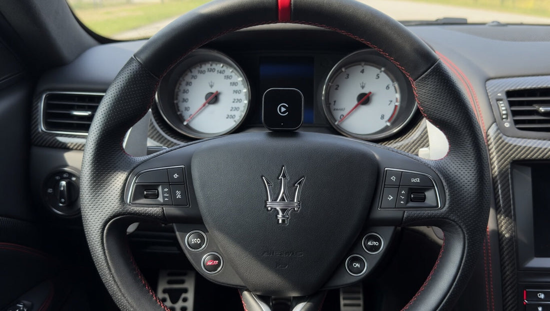 Wireless Apple CarPlay adapter placed inside a Maserati cabin. Plug-and-play infotainment upgrade for compatible Maserati models with factory wired CarPlay support.