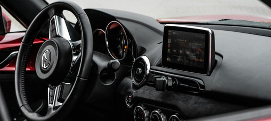 Mazda interior with infotainment screen and Apple Carplay on it connected through Motorys Wireless Carplay & Android Auto Adapter