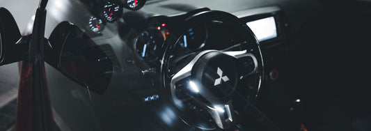 Mitsibishi interior with driving wheel and infotainment screen with apple carplay interface on the screen